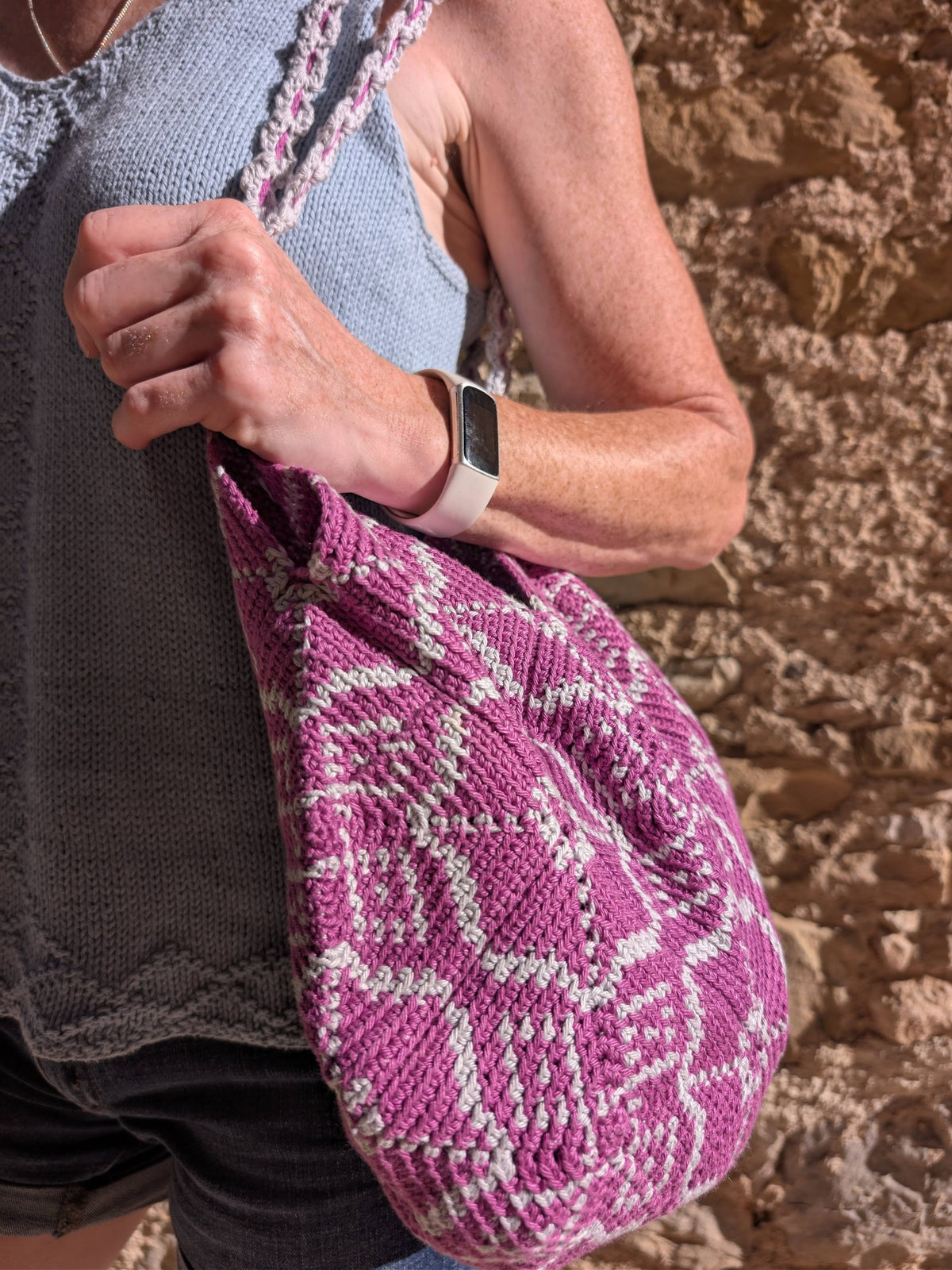 Close-up of the Pimlico bag on the shoulder, a hand on the twisted strap